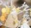 Christmas angel ornament hanging on tree with warm holiday lights