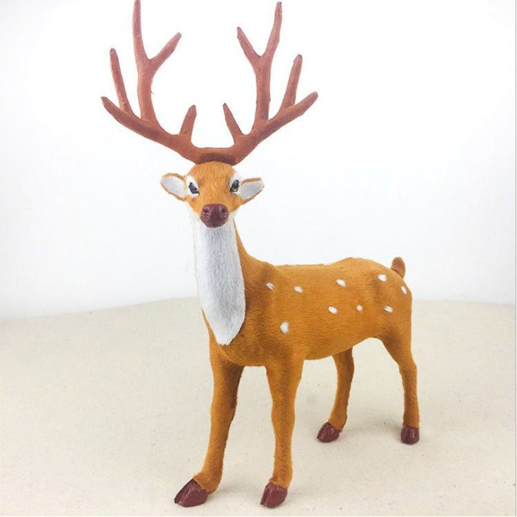 Three decorative deer figures in warm Christmas ambiance