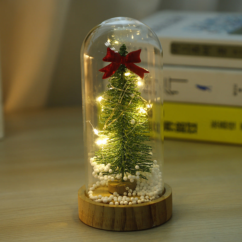 Small glass cover night light showing miniature Christmas tree motif