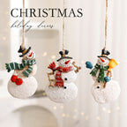 Festive elk Christmas ornament positioned among holiday greenery - Christmas decor