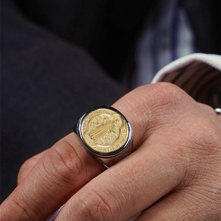 Men's religious ring in titanium steel and copper displayed on a surface