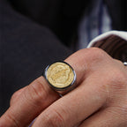 Men's religious ring in titanium steel and copper displayed on a surface