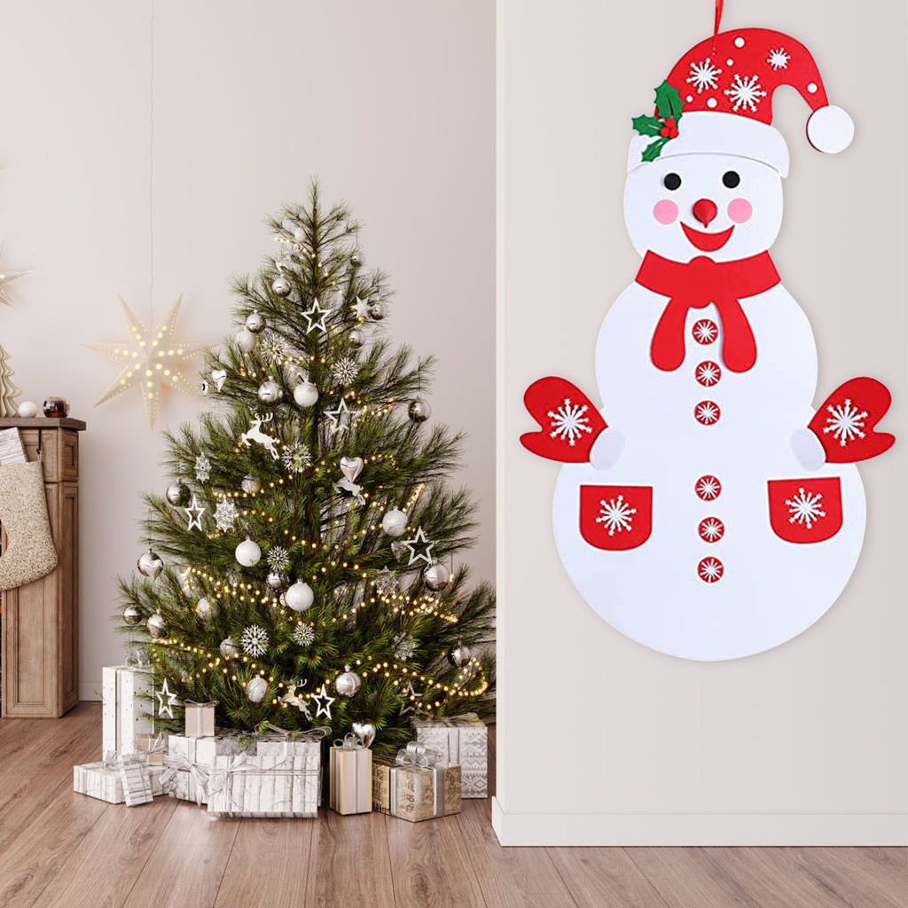 Toddler hands placing felt buttons on snowman body during craft activity