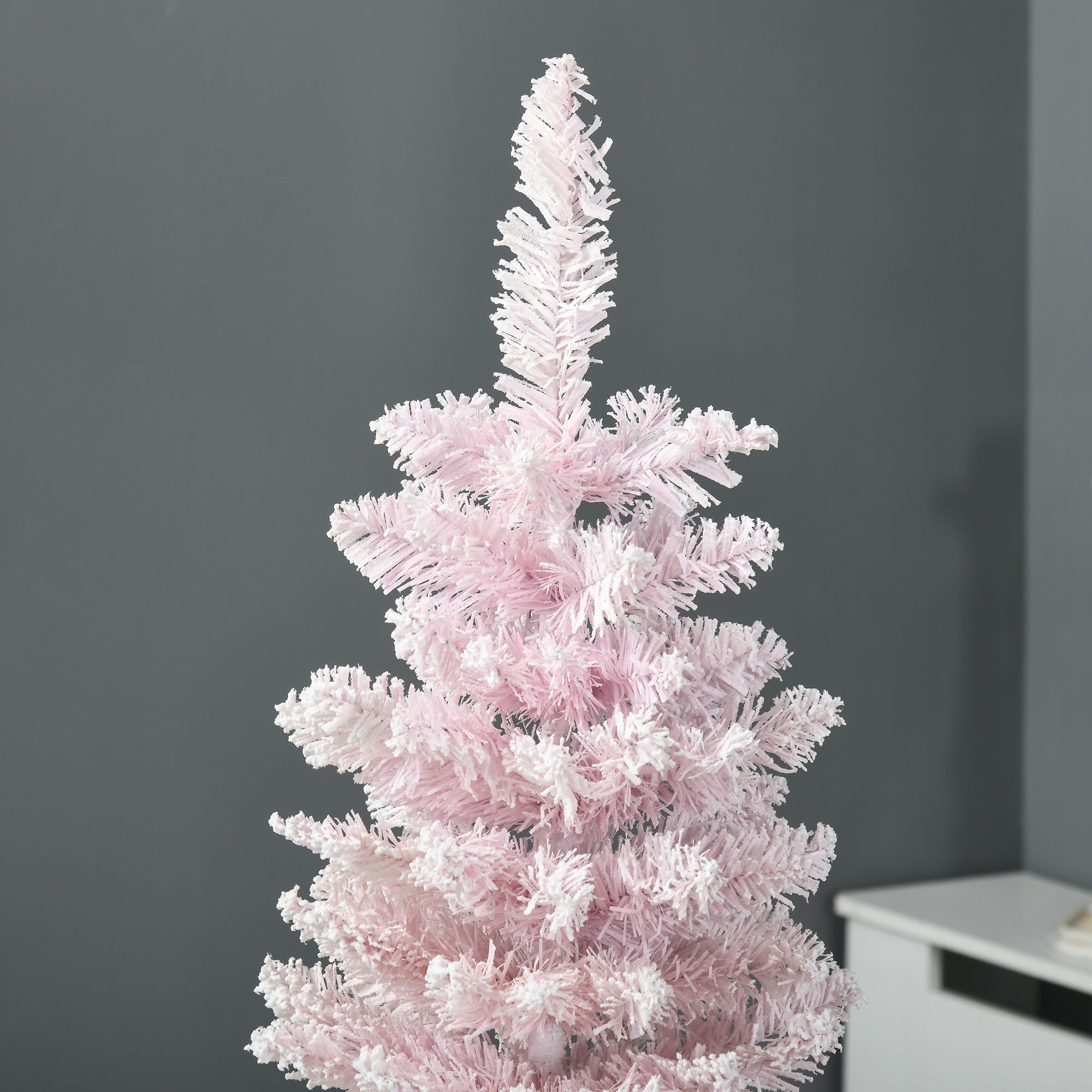 Close-up of pink flocked branches on artificial Christmas tree with 294 tips