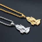 Gold-toned praying hands pendant detail