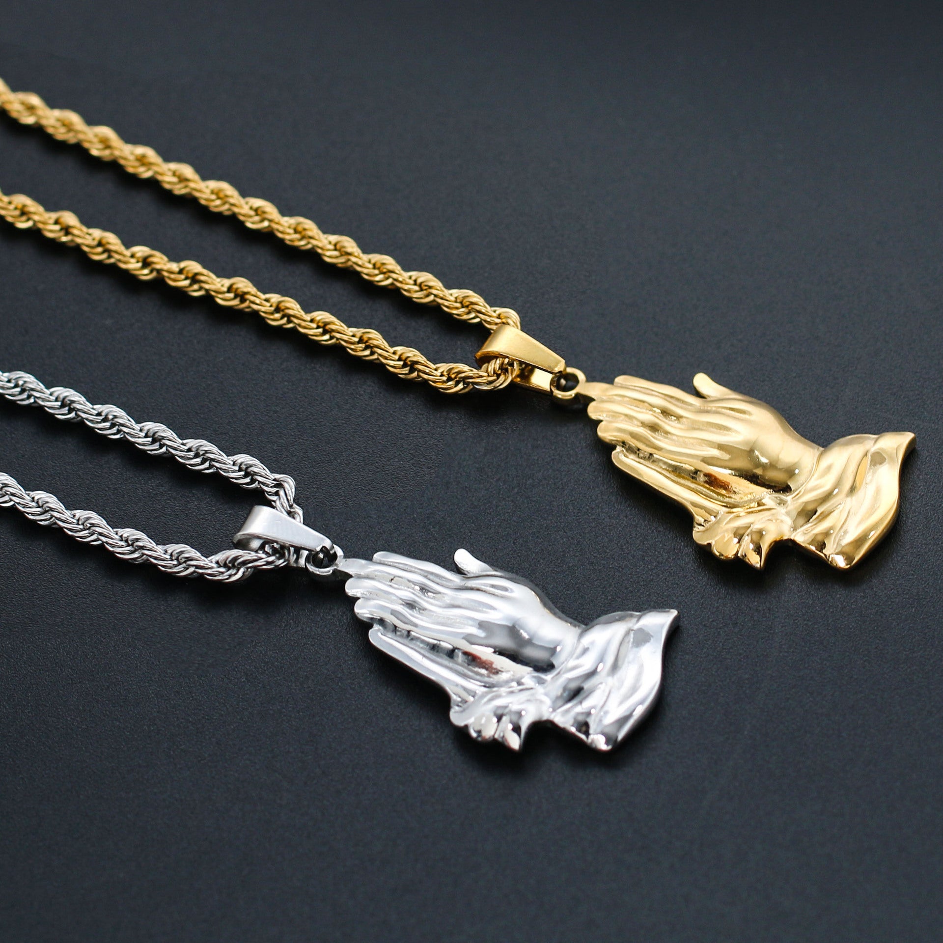 Gold-toned praying hands pendant detail