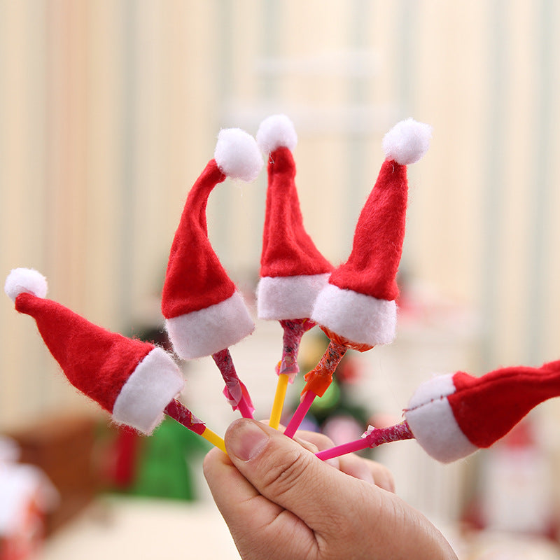 Festive red and white Christmas mini hat with lollipop cap design in non-woven fabric