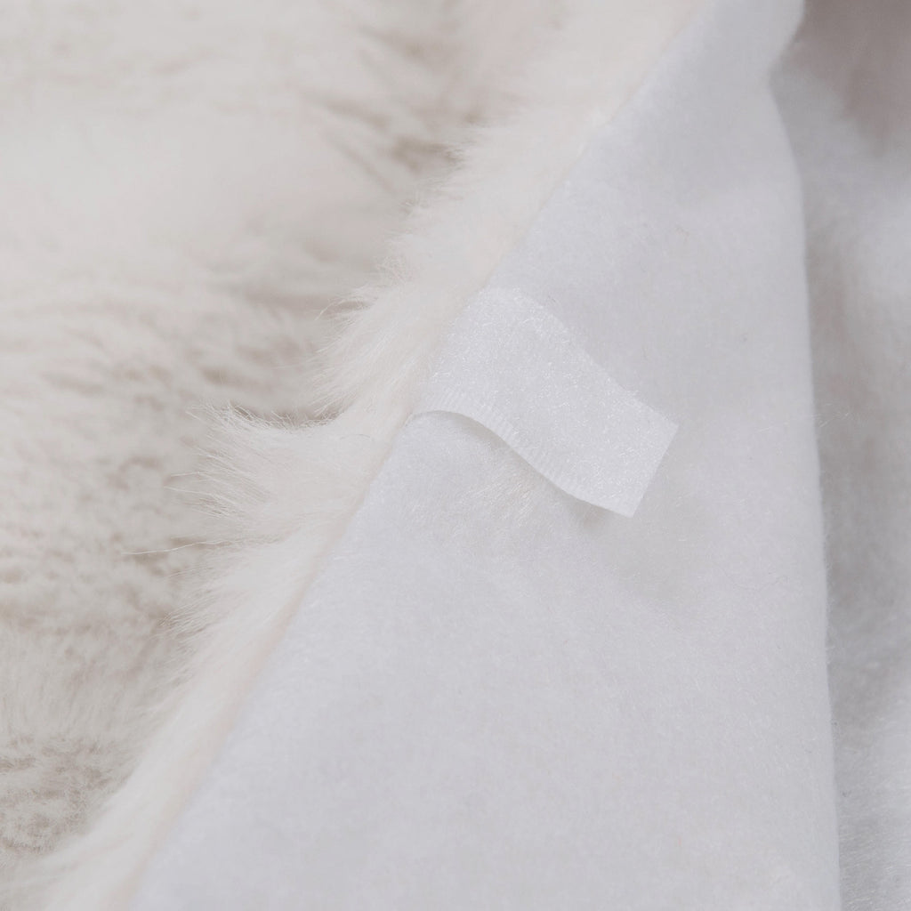 Close-up of white plush Christmas tree skirt hem displaying quality stitching and soft fabric for indoor holiday use