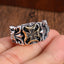 Vintage distressed cross ring with worn finish displayed on hand