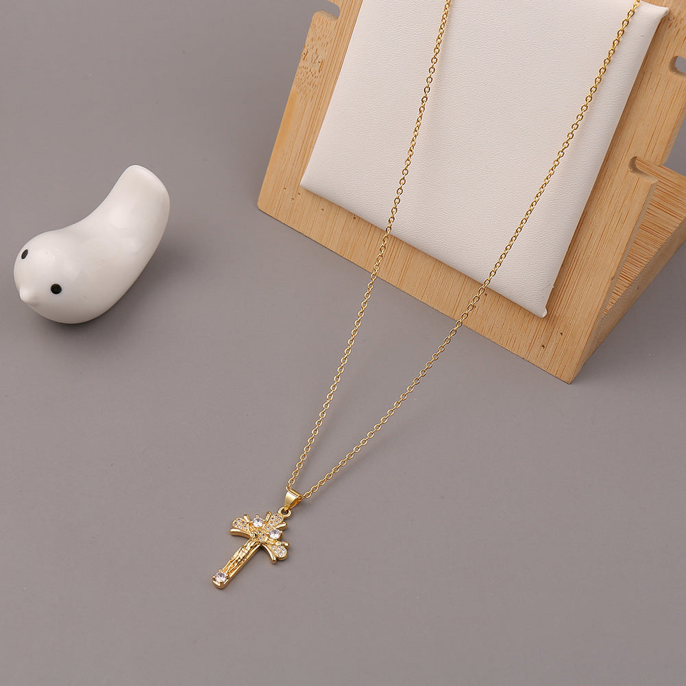 Model wearing retro cross necklace close to heart