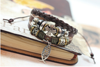 Close-up of cross and fish motifs on leather band