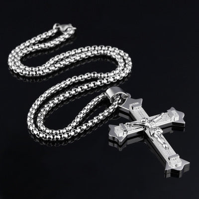 Stainless steel cross pendant necklace laid flat showing full chain length