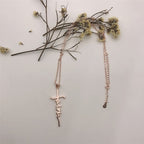 Jesus cross necklace flat lay on marble surface