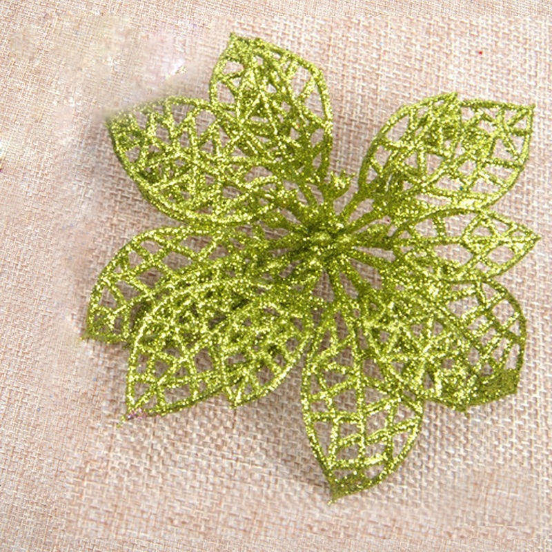 Christmas tree decorated with golden glitter flower ornaments and festive greenery