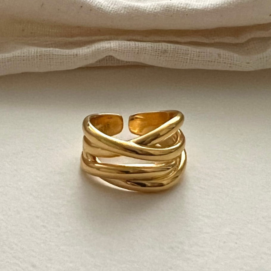 Minimalist cross ring displayed on natural wood - devotion and grace