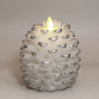Brown pinecone candle on textured surface with warm ambient lighting, Pinecone Christmas Candle, faith