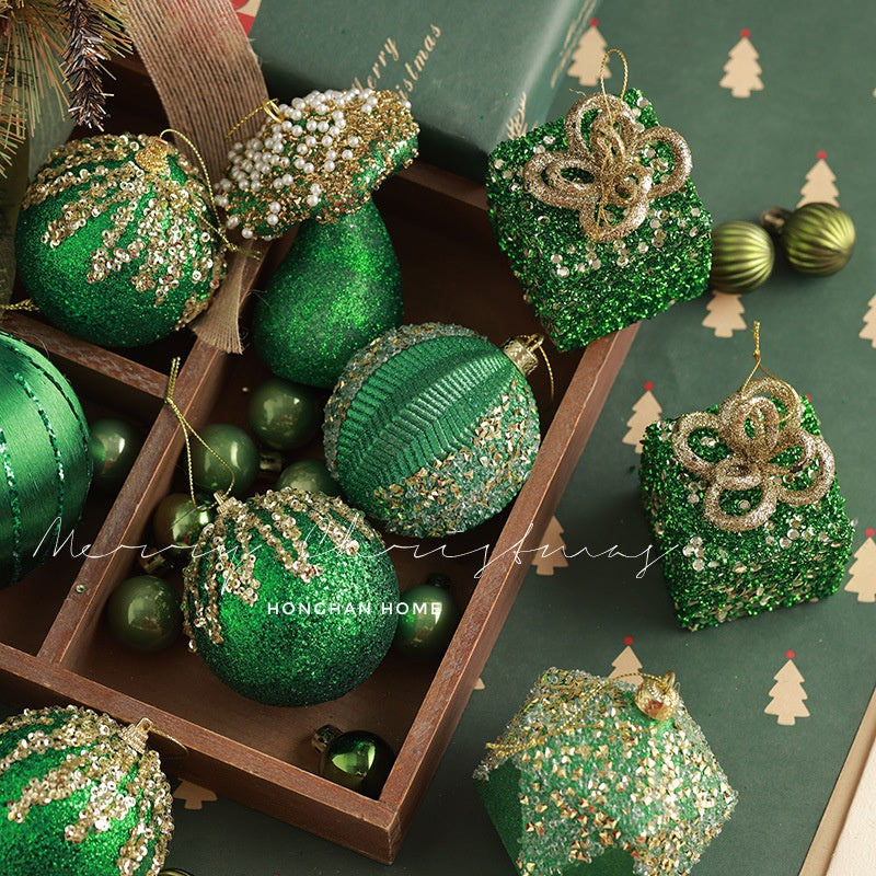 Multiple flocked green ornaments arranged for display