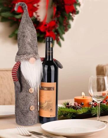 Festive faceless doll bottle cover displaying holiday charm