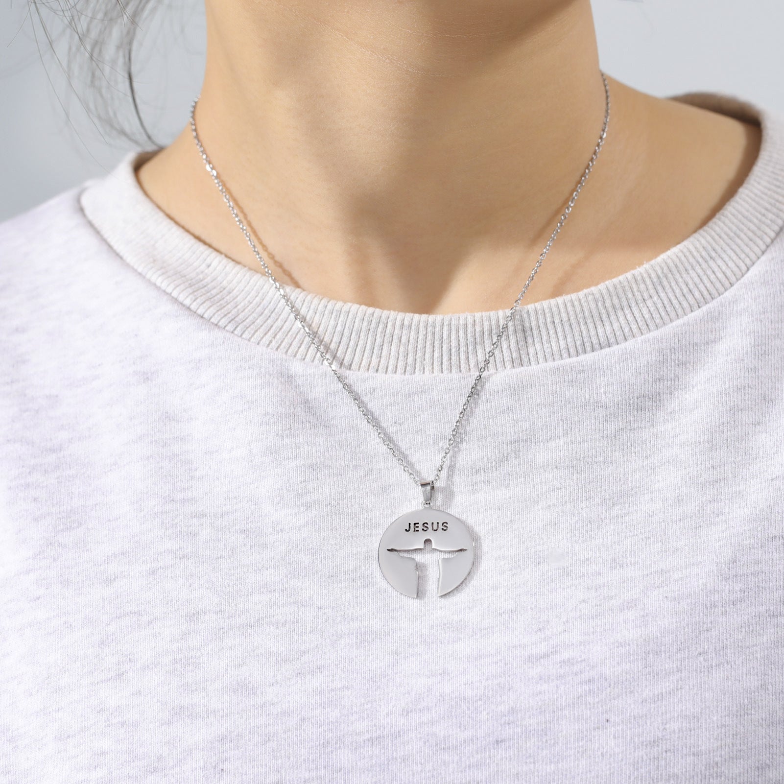 Steel-tone Jesus pendant worn by model