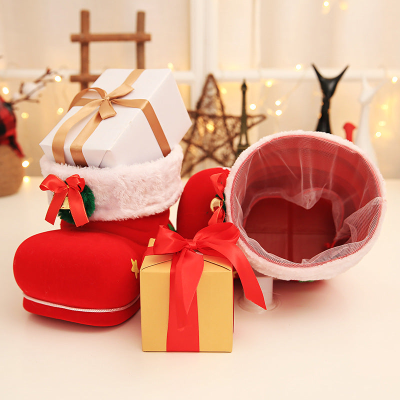 Christmas candy boot with small gift inside on wooden surface