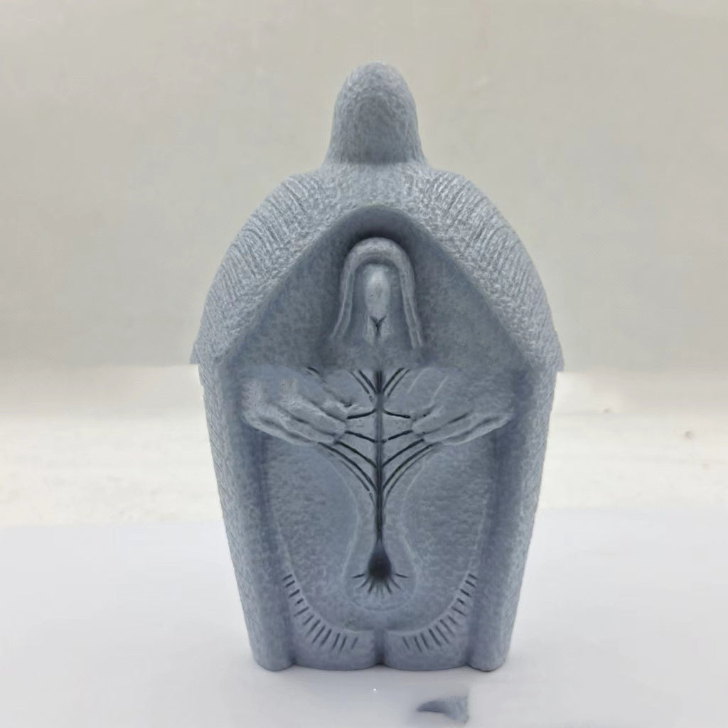Modern simple resin Jesus ornament hanging against white wall background