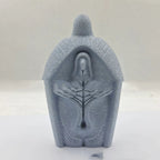 Modern simple resin Jesus ornament hanging against white wall background