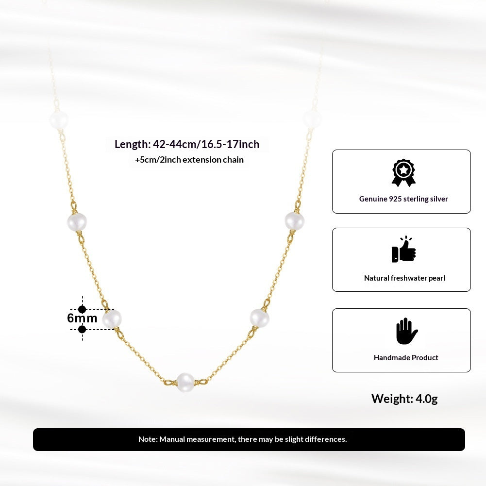 925 sterling silver necklace with pearl pendant on cross chain against white background