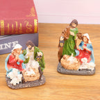 Two nativity resin ornament designs arranged together for comparison