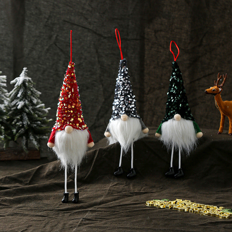Sequined Christmas doll decoration glowing softly in warm light