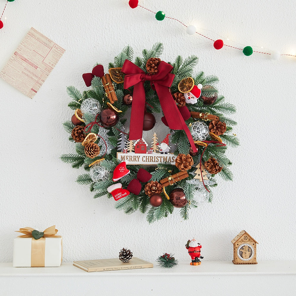 Close-up of Christmas wreath details showing pine cones, balls, and festive bow