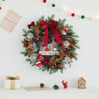 Close-up of Christmas wreath details showing pine cones, balls, and festive bow