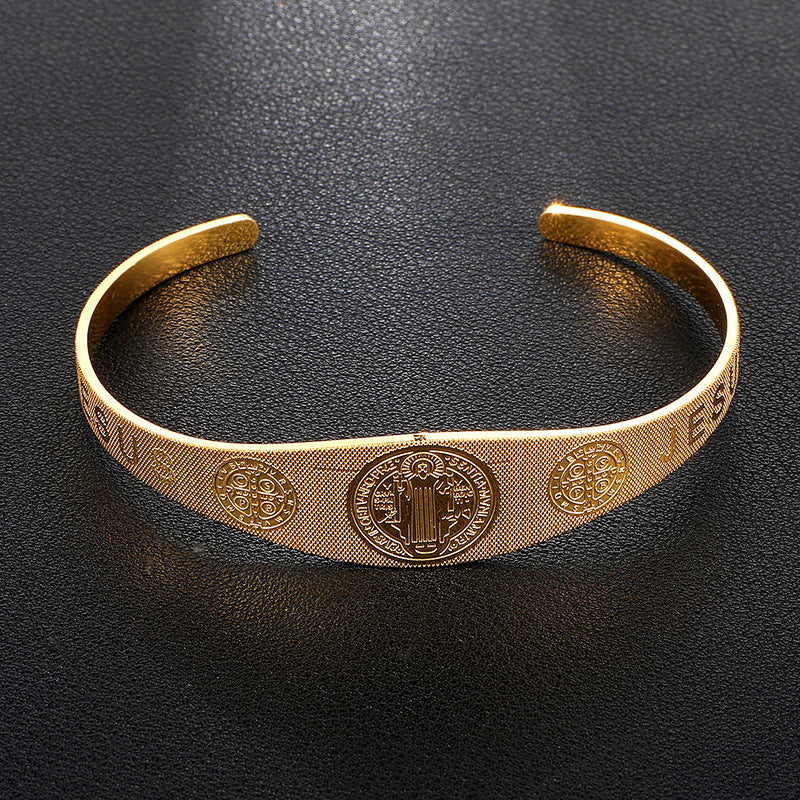 Stacked view of golden and silver Saint Benedict bracelets