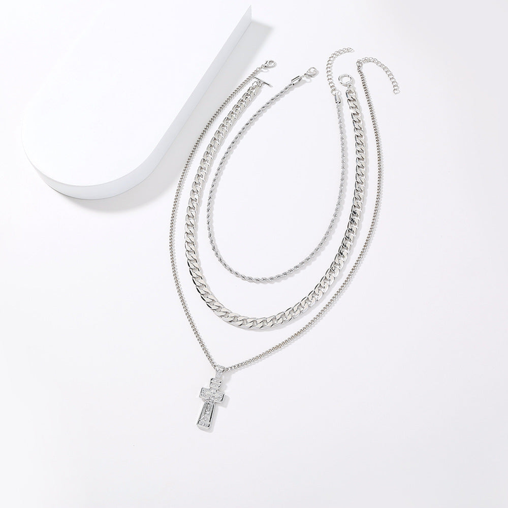 Multi-strand silver-tone necklace with cross pendant and extension chain