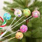 Whimsical macaron colored twig arrangement displayed as Christmas tree topper accent piece