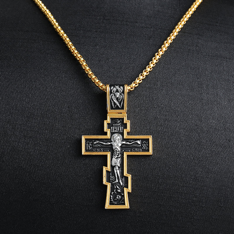 Close-up view of geometric cross pendant with two-tone finish
