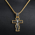 Close-up view of geometric cross pendant with two-tone finish