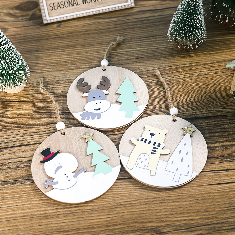 Wooden Christmas pendant hanging on tree branch showing festive holiday decoration display