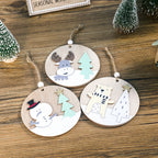 Wooden Christmas pendant hanging on tree branch showing festive holiday decoration display