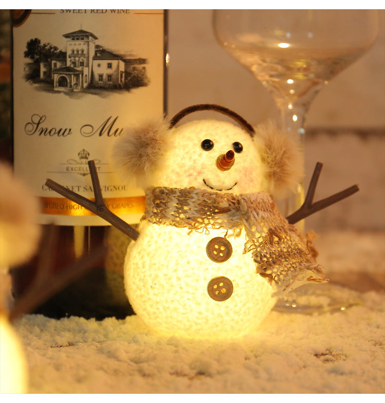 Close-up of glowing ice man ornament with plaid scarf design