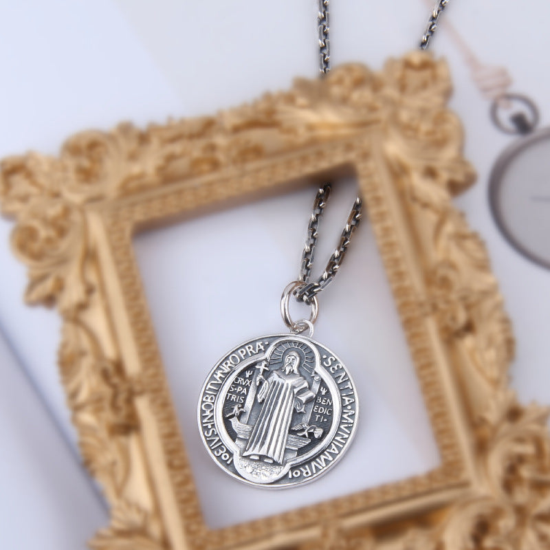 Close-up of the intricate Jesus Christ cross pendant showing fine silver craftsmanship