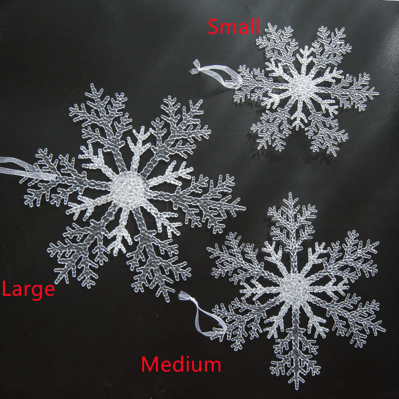 Transparent snowflake pendant displayed near window with winter light streaming through