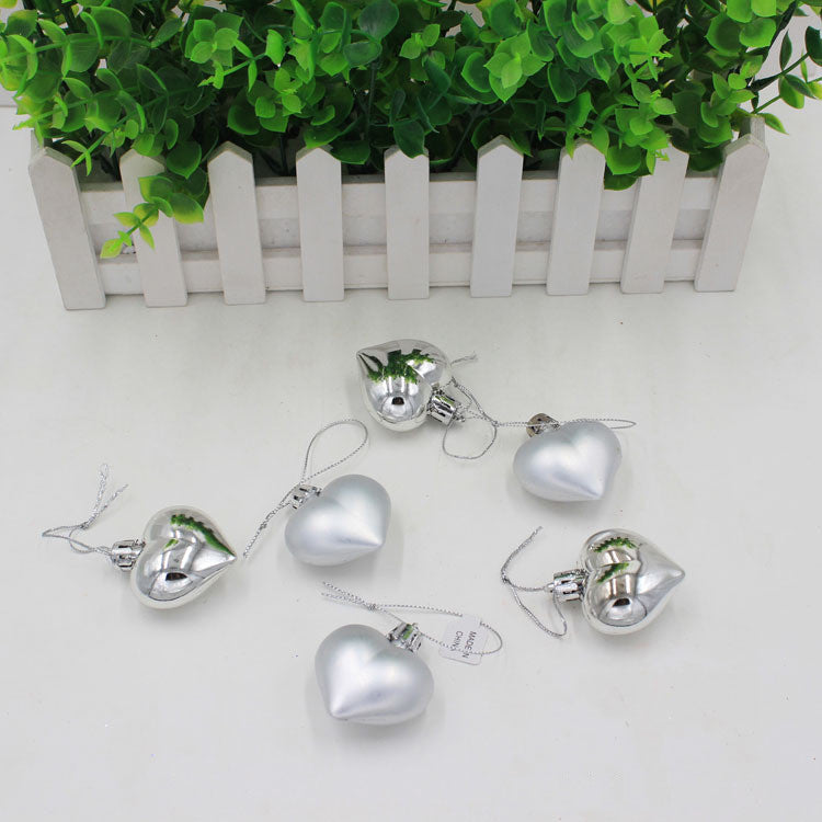 Silver peach heart Christmas pendant detail view showcasing the injection molded PVC construction