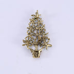 Christmas tree brooch displayed on winter sweater fabric