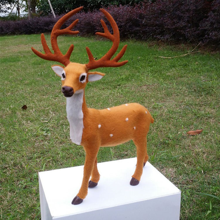 Set of three Christmas deer decorations arranged as table centerpiece