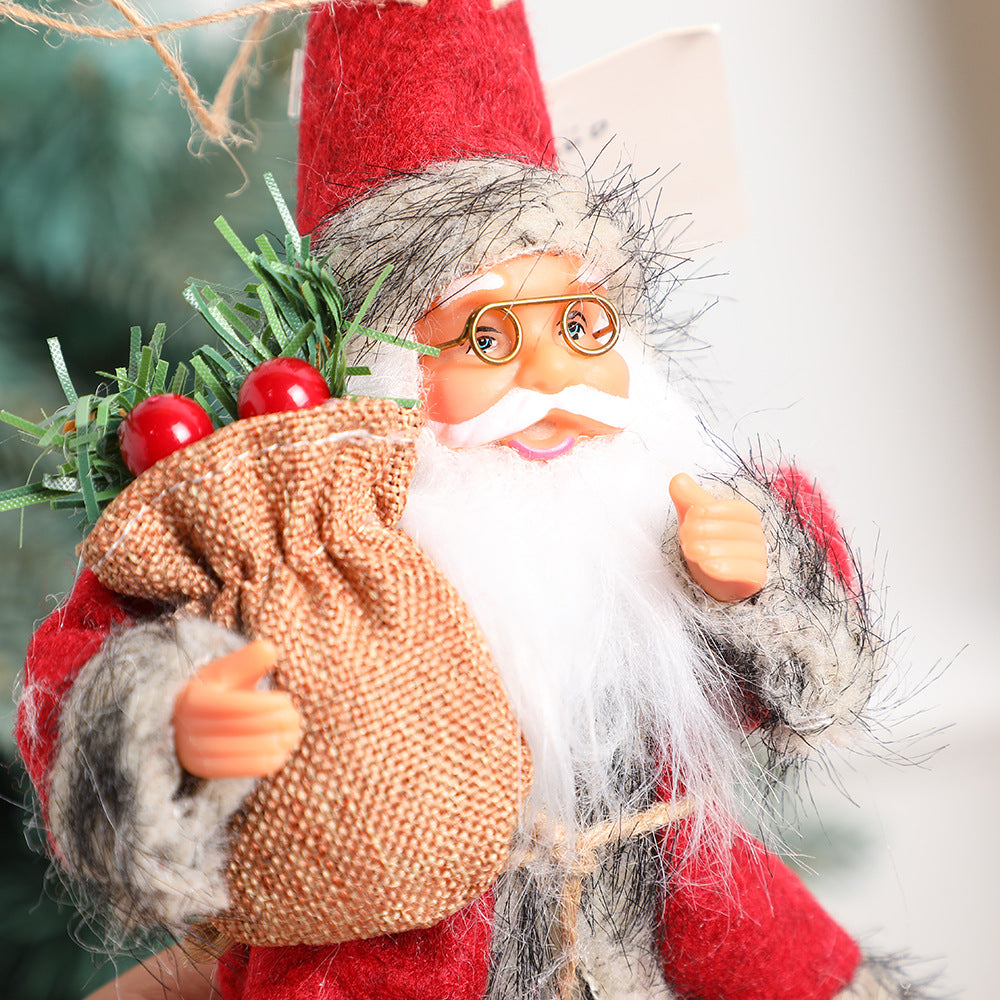 Pink Santa Claus doll next to wrapped Christmas presents