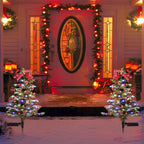 Solar Christmas tree stake light displaying dual lighting modes against a dark winter evening sky