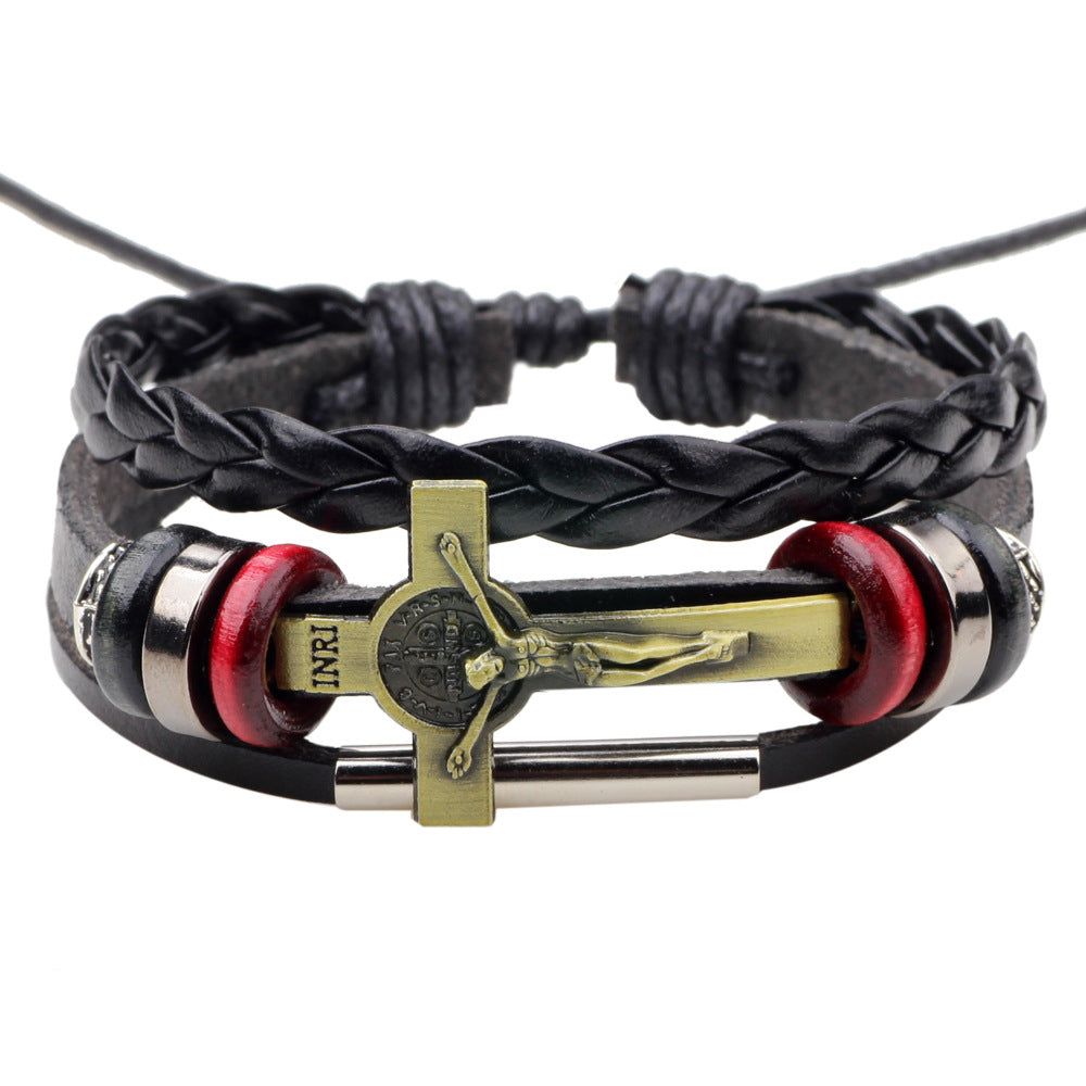 Close-up of Jesus cross emblem on vintage leather bracelet