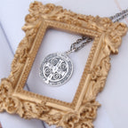 Jesus cross pendant displayed against a dark background highlighting the vintage design