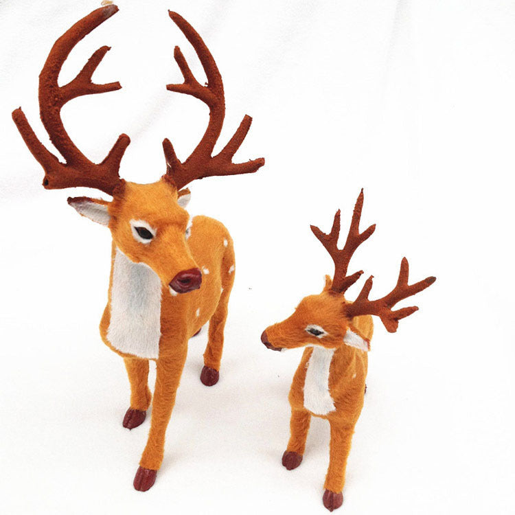 Group of three deer ornaments in graduated sizes for Christmas window display
