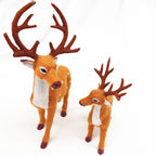 Group of three deer ornaments in graduated sizes for Christmas window display